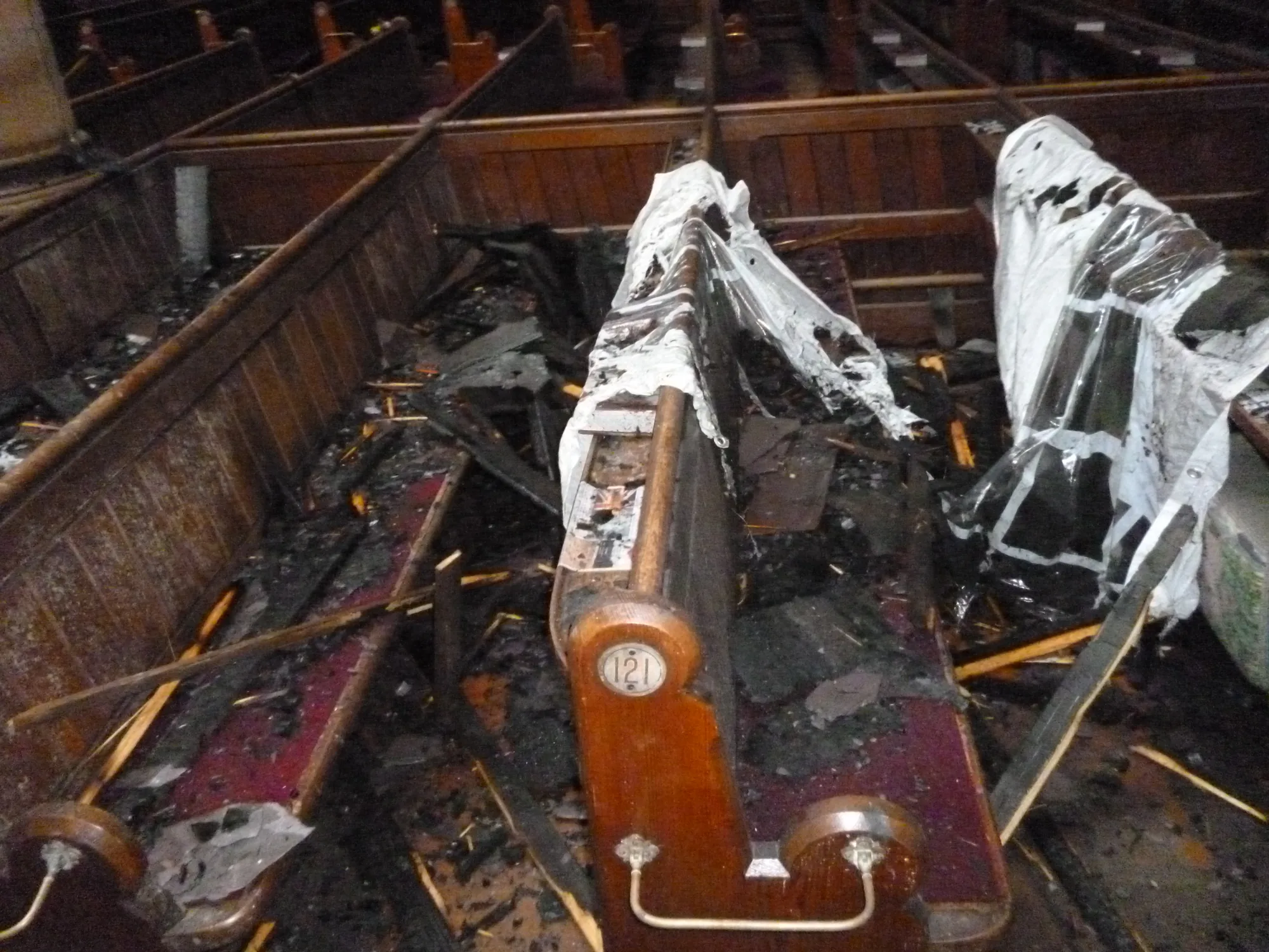 Fire-damaged pews inside Bangor Parish Church