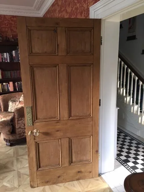 Restored panelled pine door with period brass ironmongery