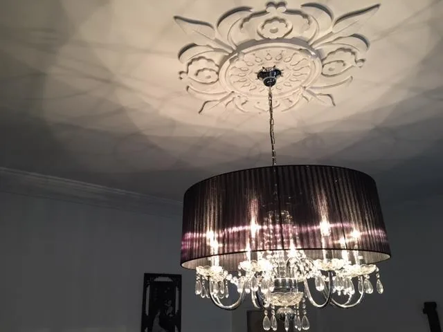 Restored decorative ceiling rose and contemporary chandelier