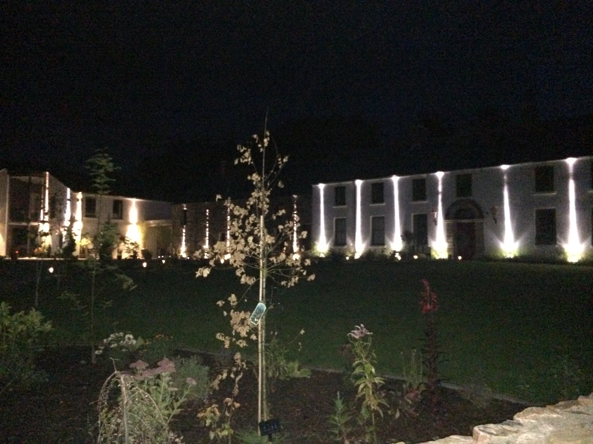Ling House and landscaped grounds illuminated at night