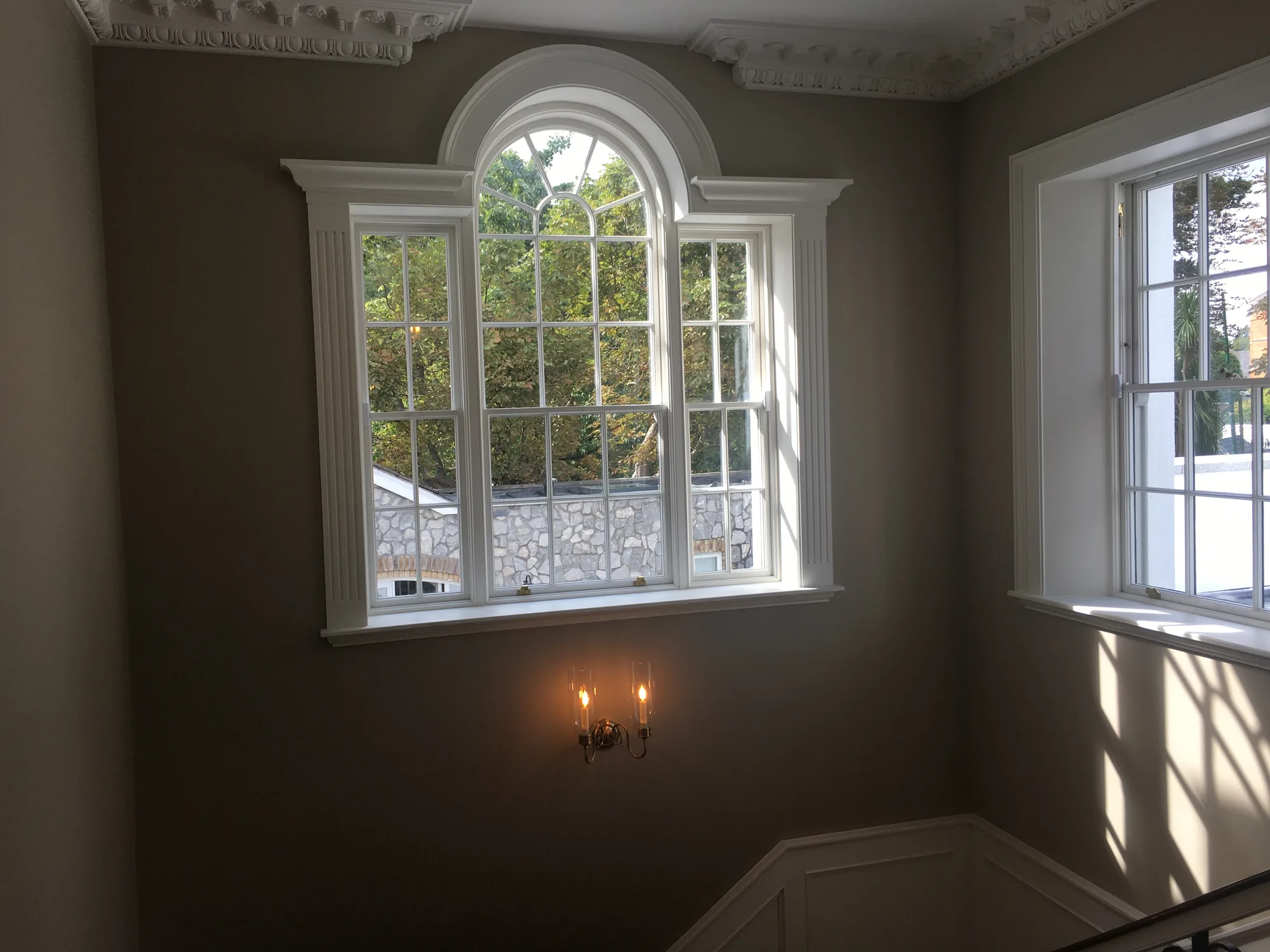 Restored arched window and decorative plasterwork at Richview House