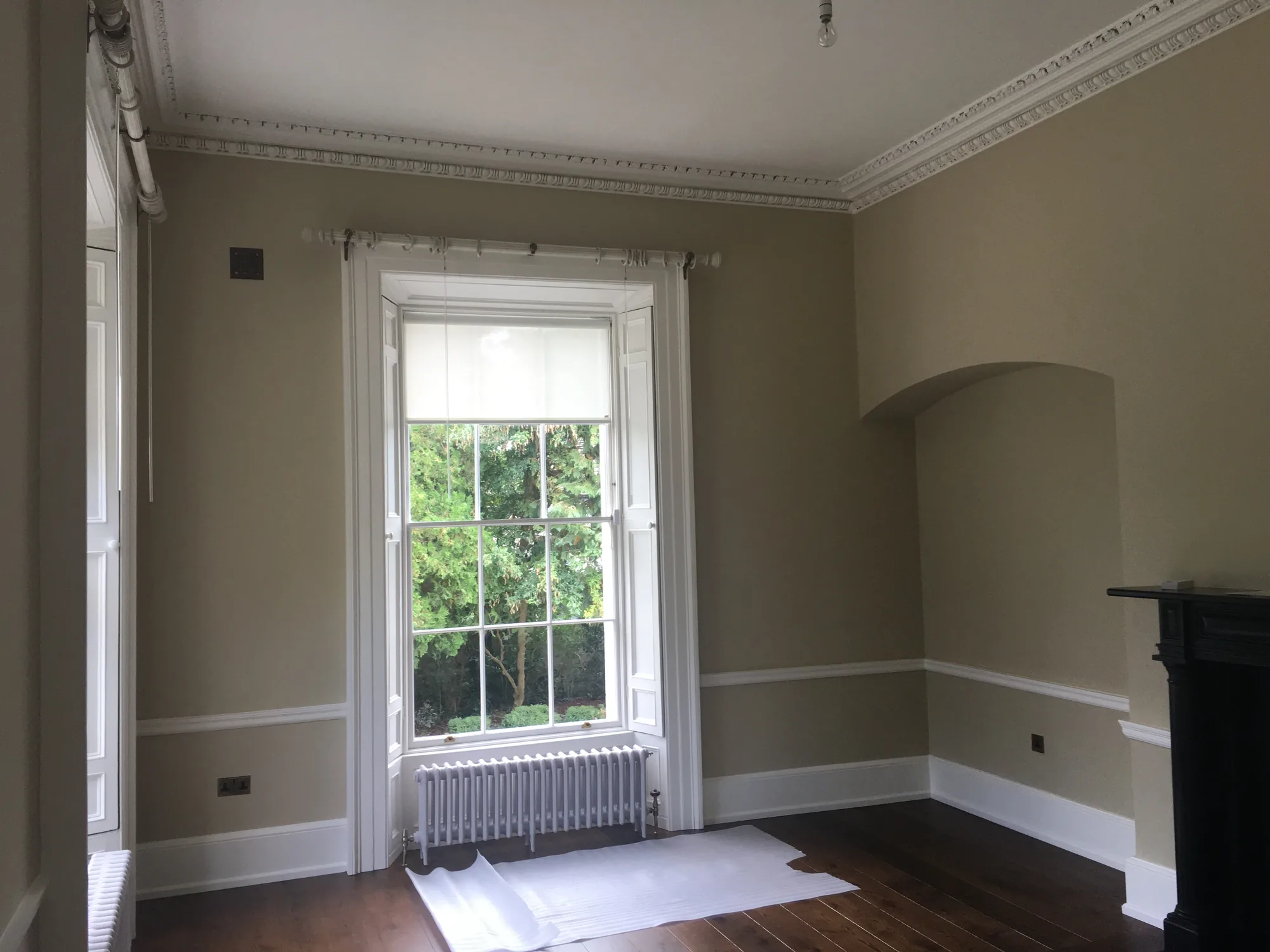 Restored room with sash window and decorative cornice at Richview House