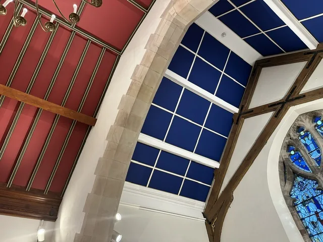 Decorative blue ceiling and stone arch at St Colman’s